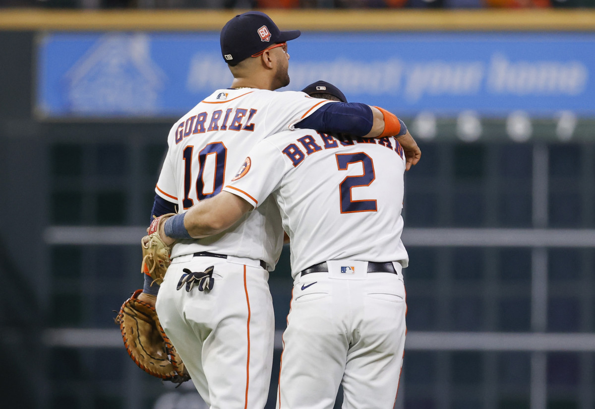 Yuli Gurriel puts his arm around Houston Astros teammate Alex Bregman.